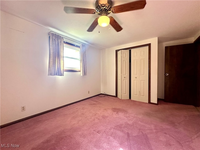 unfurnished bedroom with ceiling fan, carpet flooring, and a closet