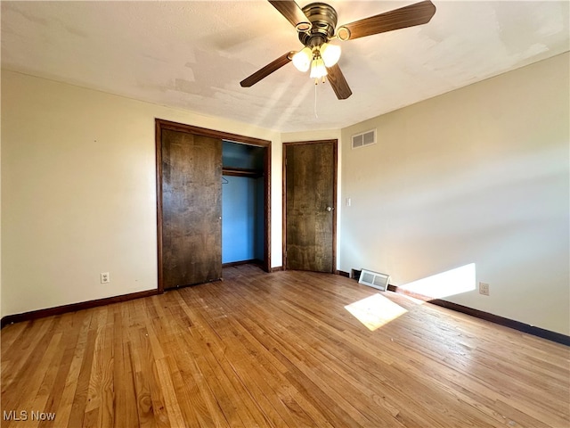 unfurnished bedroom featuring a closet, ceiling fan, and light hardwood / wood-style flooring