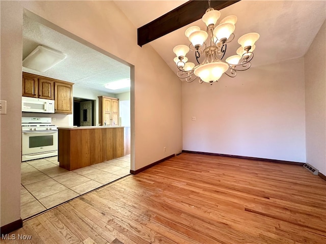 kitchen with lofted ceiling with beams, light wood-type flooring, white appliances, and kitchen peninsula