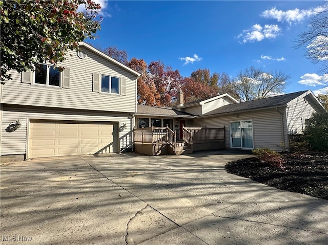 view of side of property featuring a garage and a deck