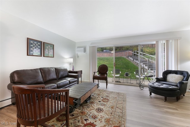 living room with light wood-type flooring and a wall mounted air conditioner