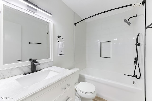 full bathroom featuring toilet, tiled shower / bath combo, and vanity