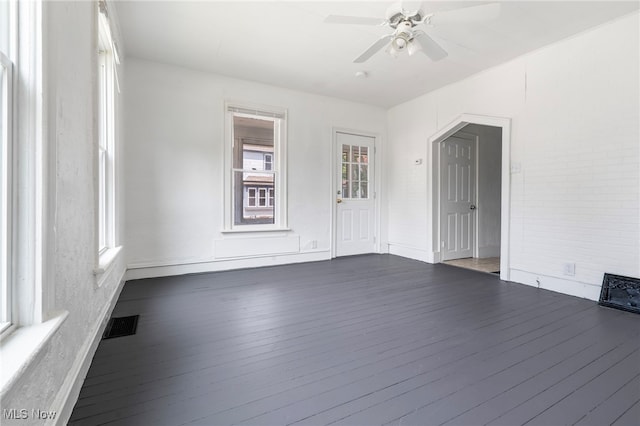 spare room with ceiling fan and dark wood-type flooring