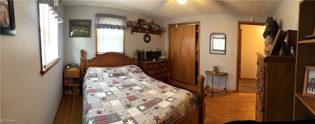 bedroom with hardwood / wood-style floors, ceiling fan, and vaulted ceiling