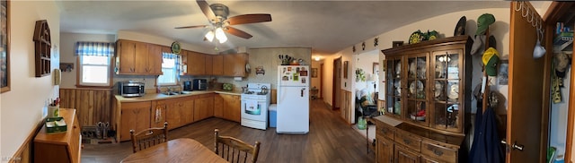 kitchen featuring sink, ceiling fan, backsplash, white appliances, and dark hardwood / wood-style flooring