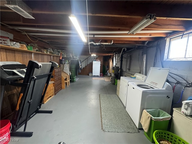 basement featuring washing machine and clothes dryer and water heater