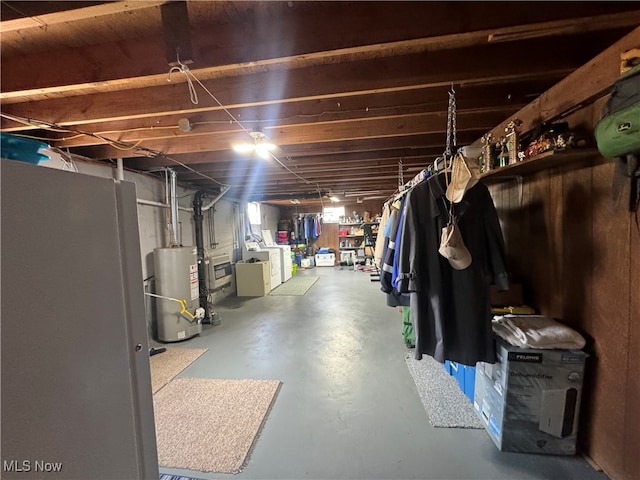 basement with water heater and separate washer and dryer