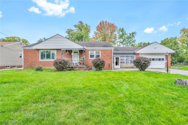 ranch-style home featuring a front lawn and a garage