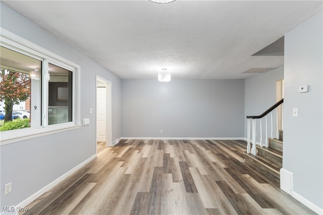 unfurnished room with hardwood / wood-style flooring