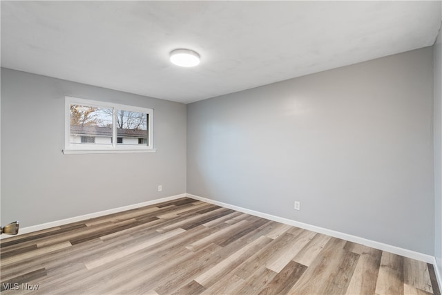 empty room with hardwood / wood-style flooring