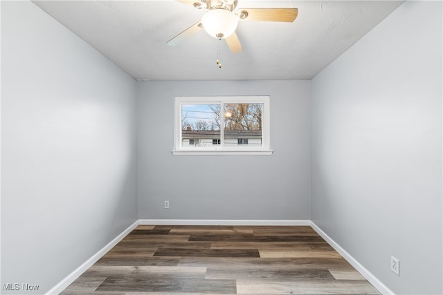 empty room featuring dark wood-type flooring and ceiling fan