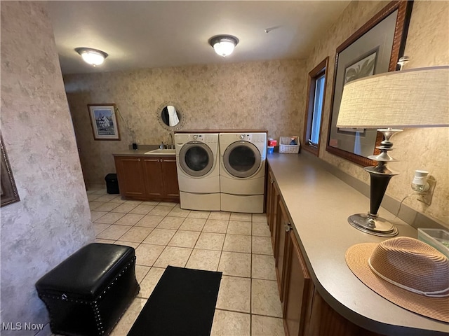 laundry area with sink, independent washer and dryer, and light tile patterned flooring