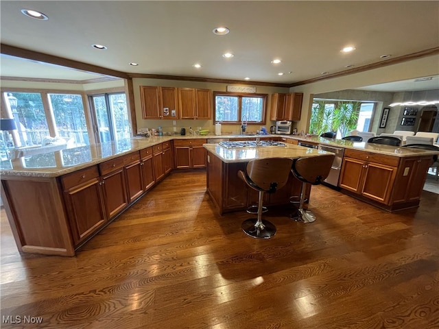 kitchen with a kitchen island, kitchen peninsula, and a healthy amount of sunlight