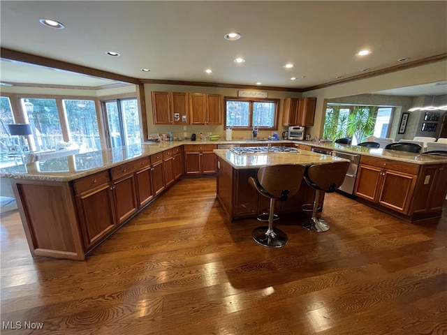 kitchen with kitchen peninsula, a wealth of natural light, and a kitchen island