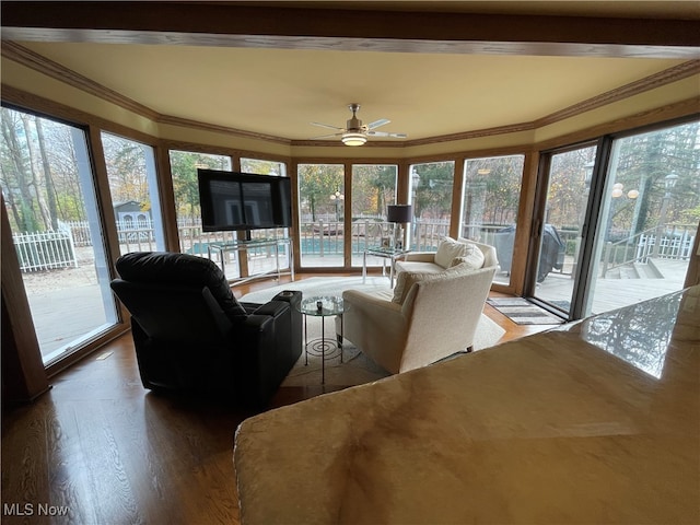 sunroom / solarium featuring ceiling fan