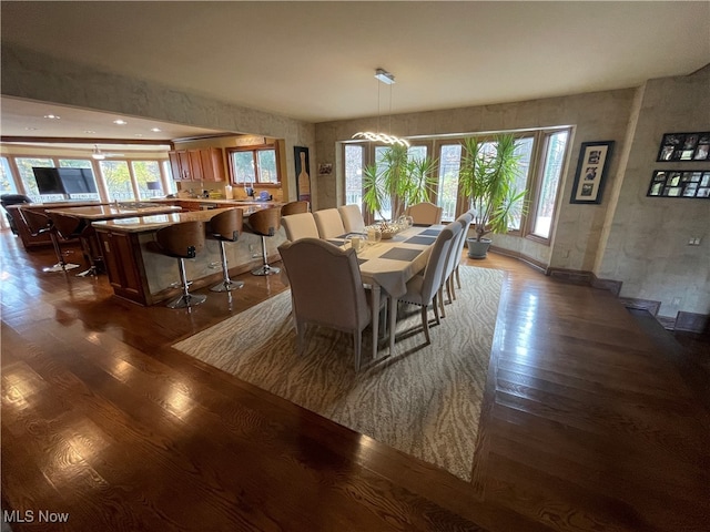 dining area featuring dark wood-type flooring