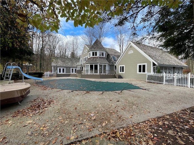 rear view of house featuring a wooden deck