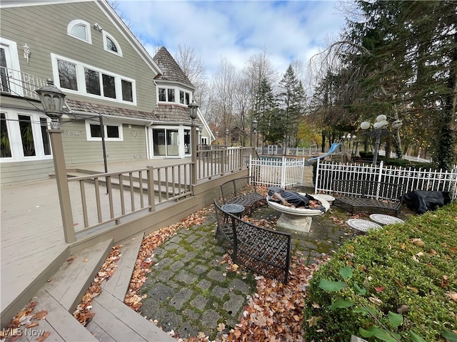 wooden terrace featuring an outdoor fire pit