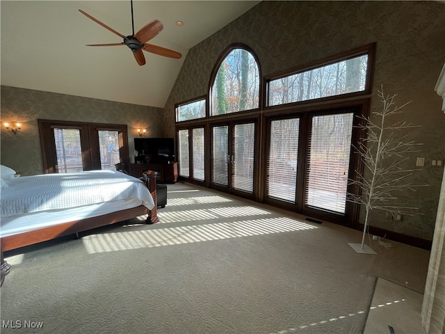 unfurnished bedroom featuring high vaulted ceiling, ceiling fan, and carpet