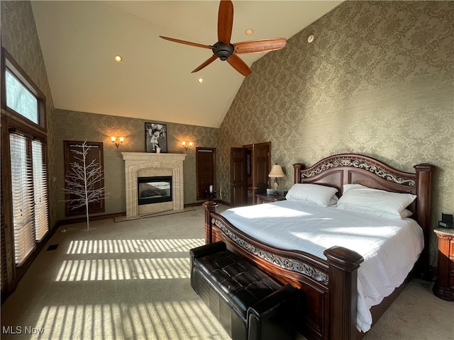 bedroom with high vaulted ceiling, ceiling fan, and carpet