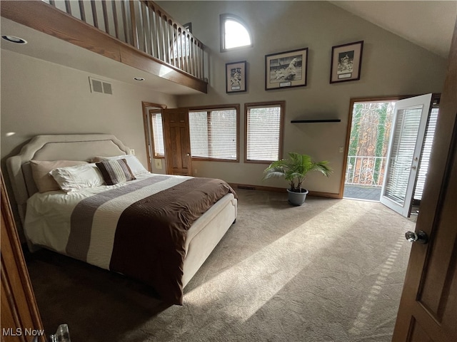 bedroom featuring high vaulted ceiling, access to outside, multiple windows, and carpet