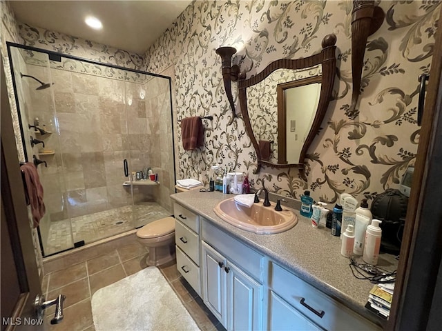 bathroom featuring vanity, tile patterned floors, an enclosed shower, and toilet