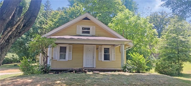 bungalow with a porch and a front yard