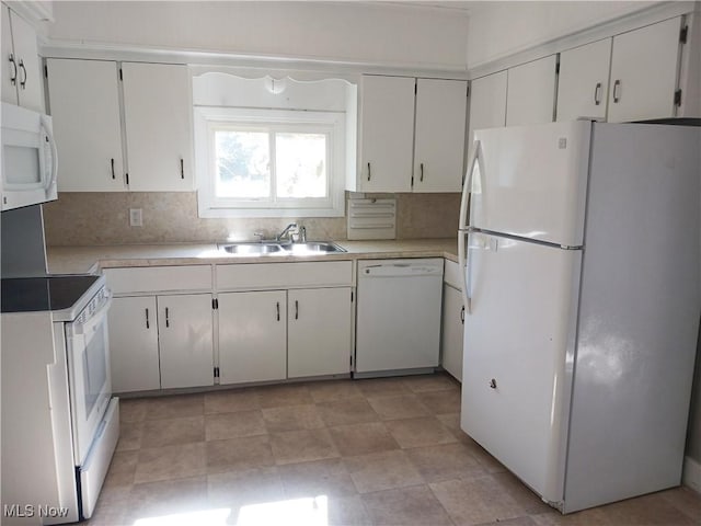 kitchen with white cabinets, white appliances, sink, and tasteful backsplash