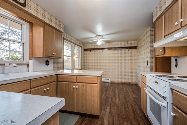 kitchen featuring sink, white range with electric stovetop, ceiling fan, dark hardwood / wood-style floors, and a baseboard heating unit