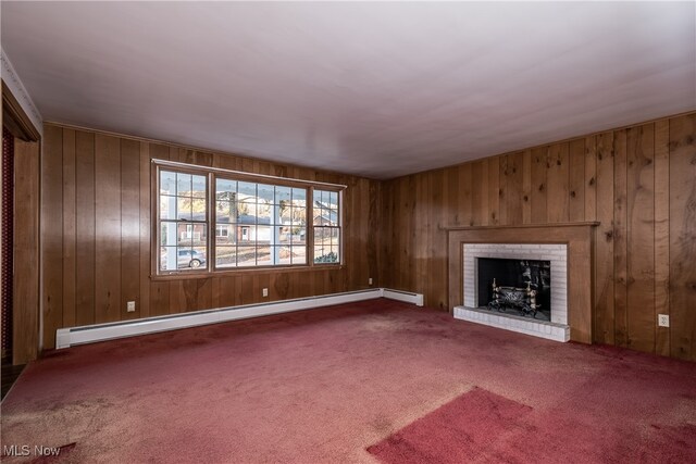 unfurnished living room featuring a baseboard heating unit, a fireplace, wooden walls, and carpet