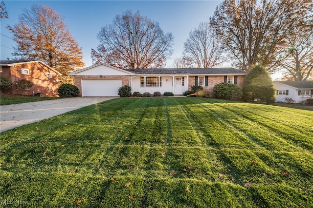 single story home featuring a front lawn and a garage