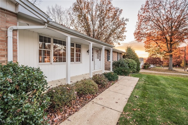 exterior entry at dusk with a yard