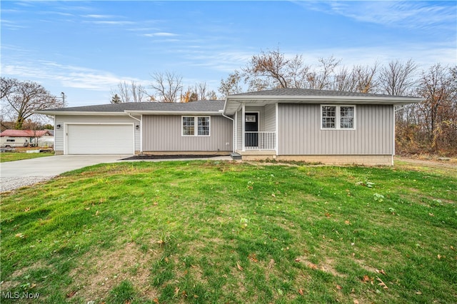 ranch-style home featuring covered porch, a garage, and a front yard