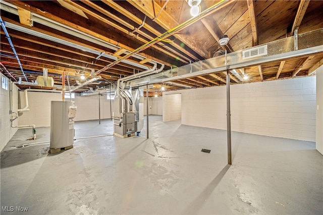 basement featuring gas water heater and heating unit