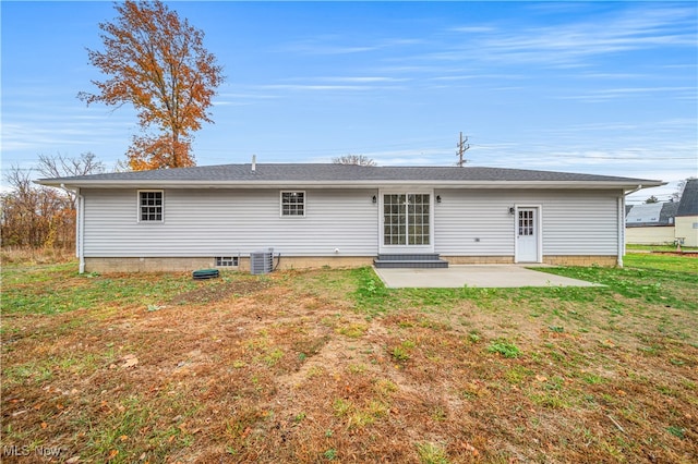 back of house featuring cooling unit, a yard, and a patio area