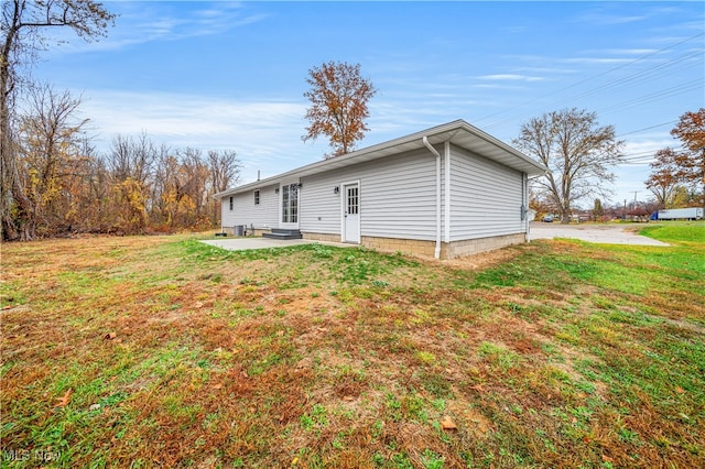 rear view of property with a patio and a yard