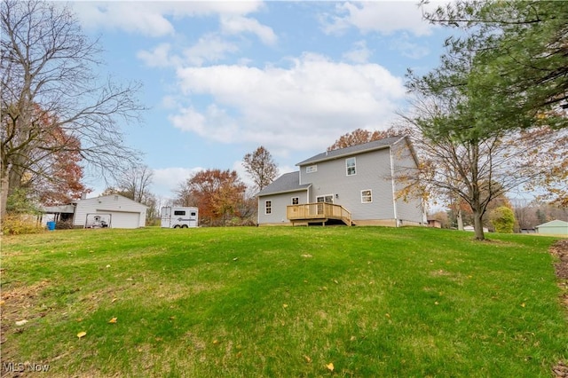 view of yard featuring a garage and a wooden deck