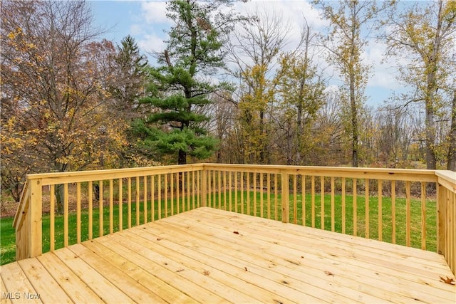 wooden deck featuring a yard