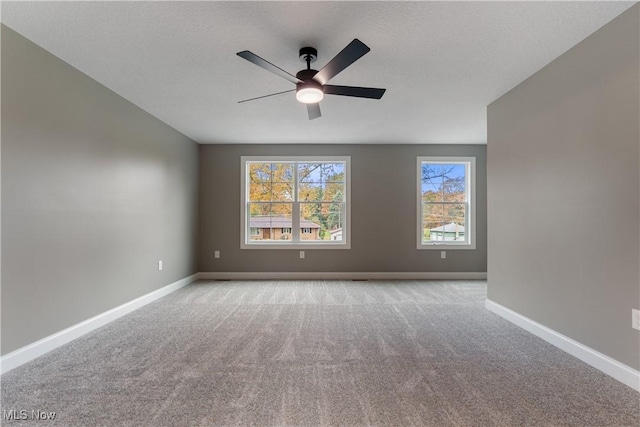 empty room with light colored carpet and ceiling fan