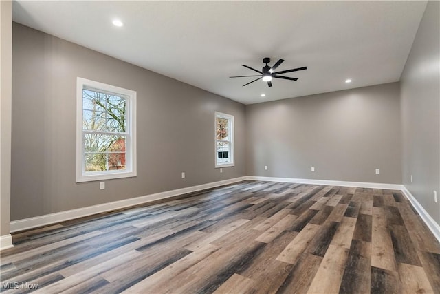 empty room with hardwood / wood-style floors and ceiling fan