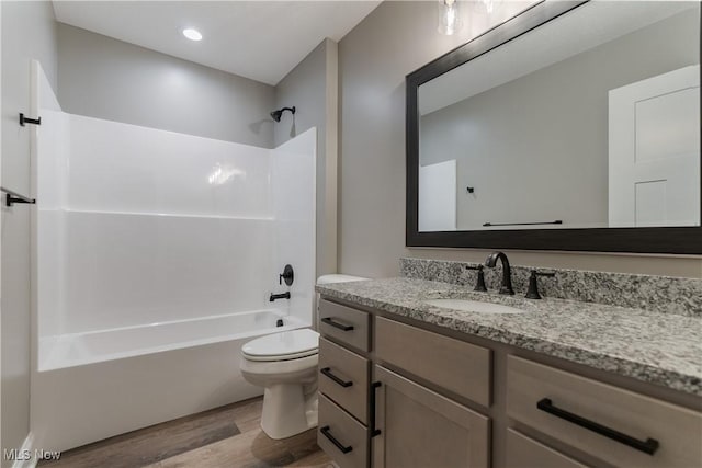 full bathroom featuring shower / bathing tub combination, vanity, hardwood / wood-style flooring, and toilet