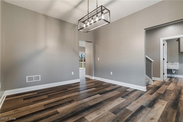 unfurnished dining area with dark hardwood / wood-style flooring