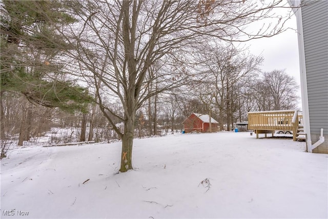 snowy yard with a wooden deck