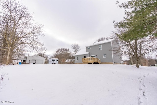 yard covered in snow featuring a deck