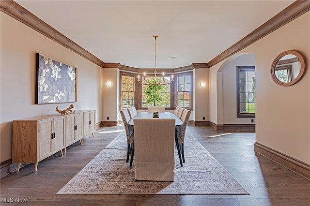 dining space featuring a chandelier, dark hardwood / wood-style floors, and crown molding