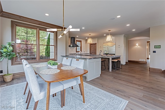 dining space featuring light hardwood / wood-style floors and sink