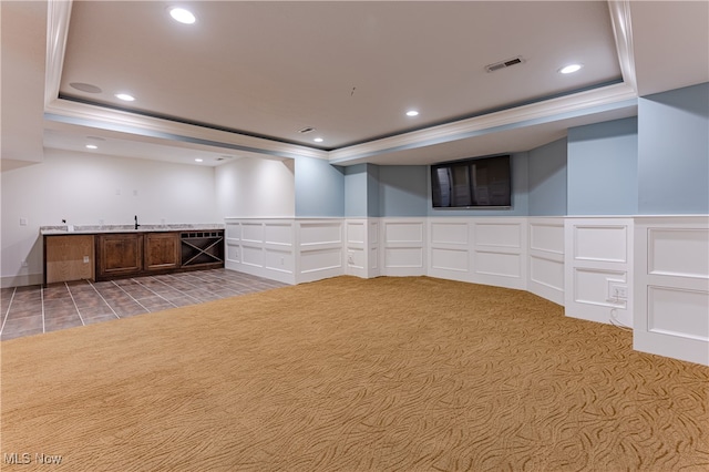 basement with light carpet and ornamental molding