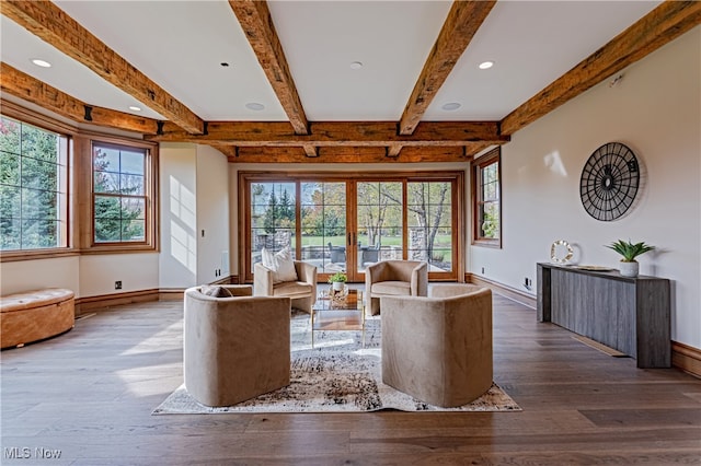 unfurnished living room with dark wood-type flooring, a wealth of natural light, french doors, and beam ceiling