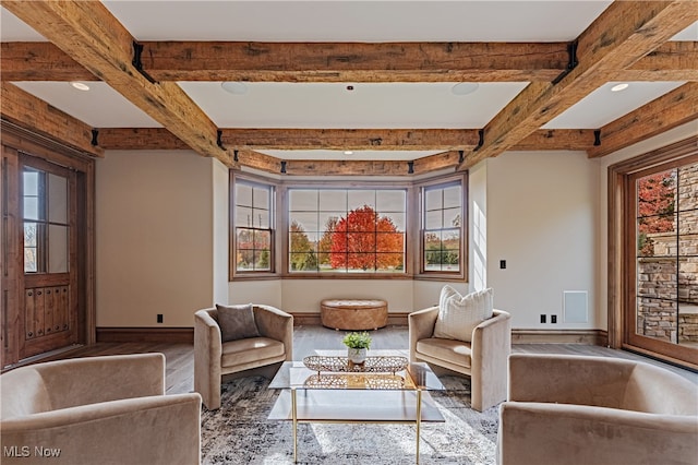 living area featuring beamed ceiling and hardwood / wood-style floors