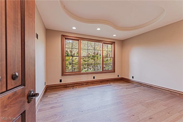 unfurnished room with light wood-type flooring